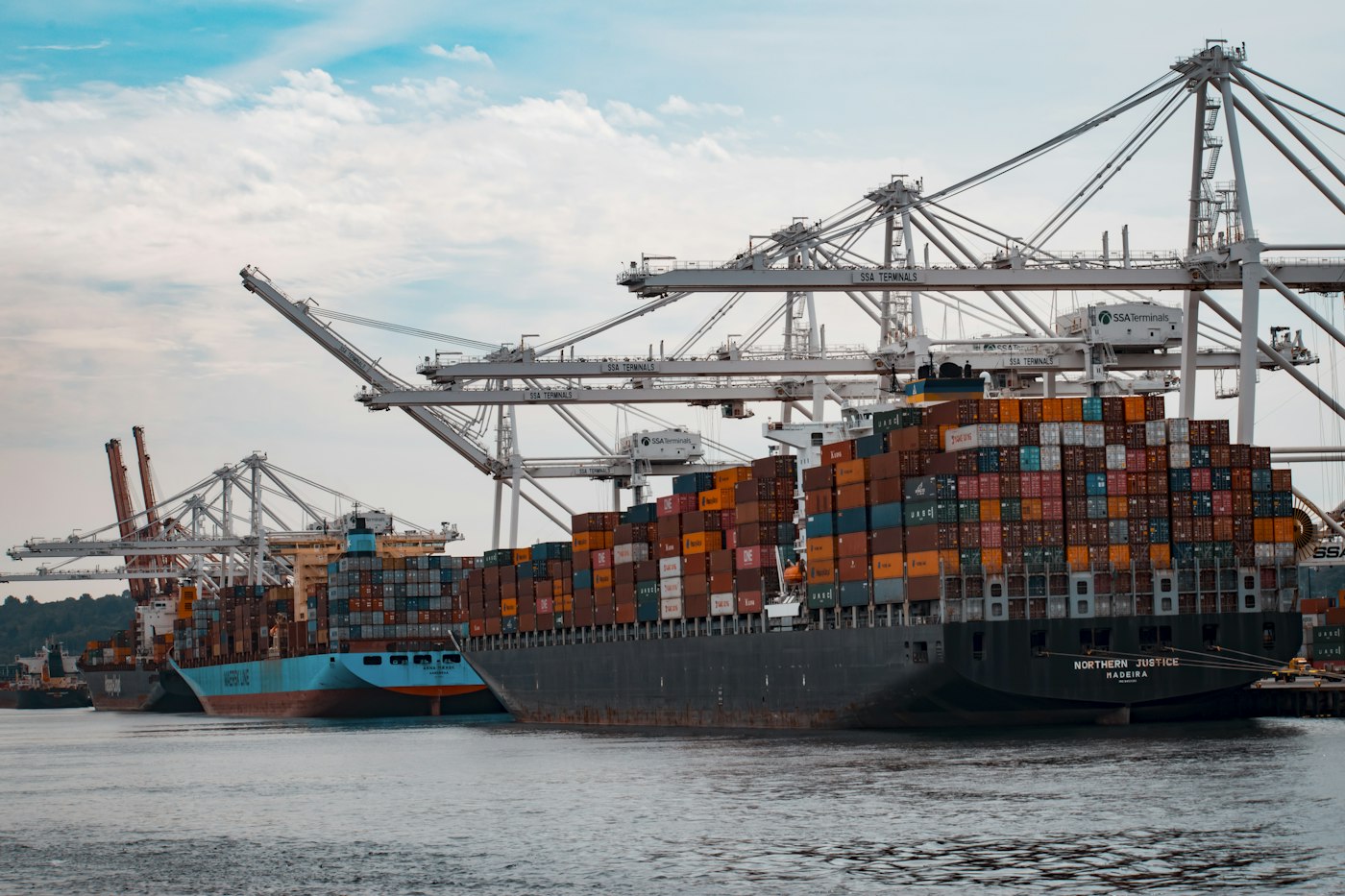 Container ships alongside cranes in a harbour